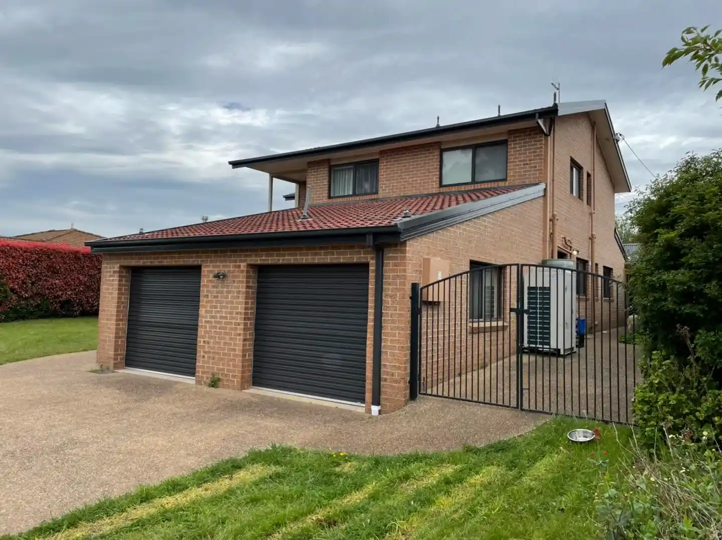 Front view of the Canberra home with double garage and restored terracotta roof