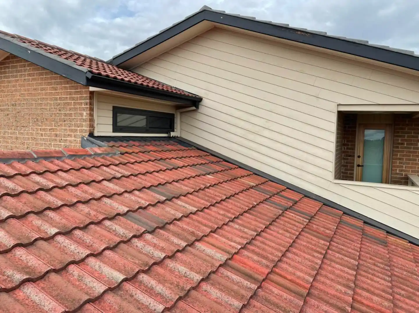 Close-up of restored terracotta roof tiles and ridge capping on the Canberra home