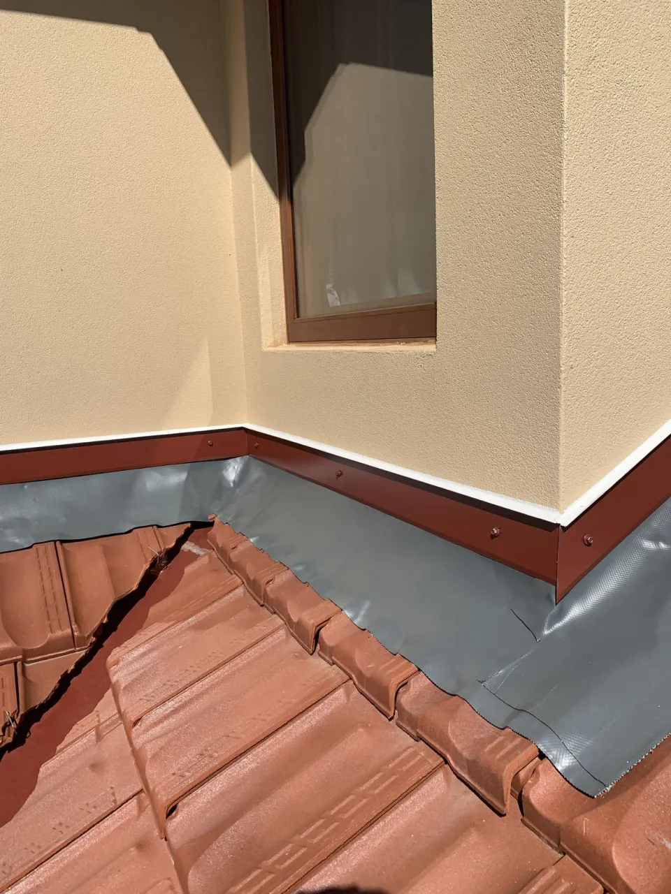Wakaflex flashing installed at a roof-to-wall corner on the cottage