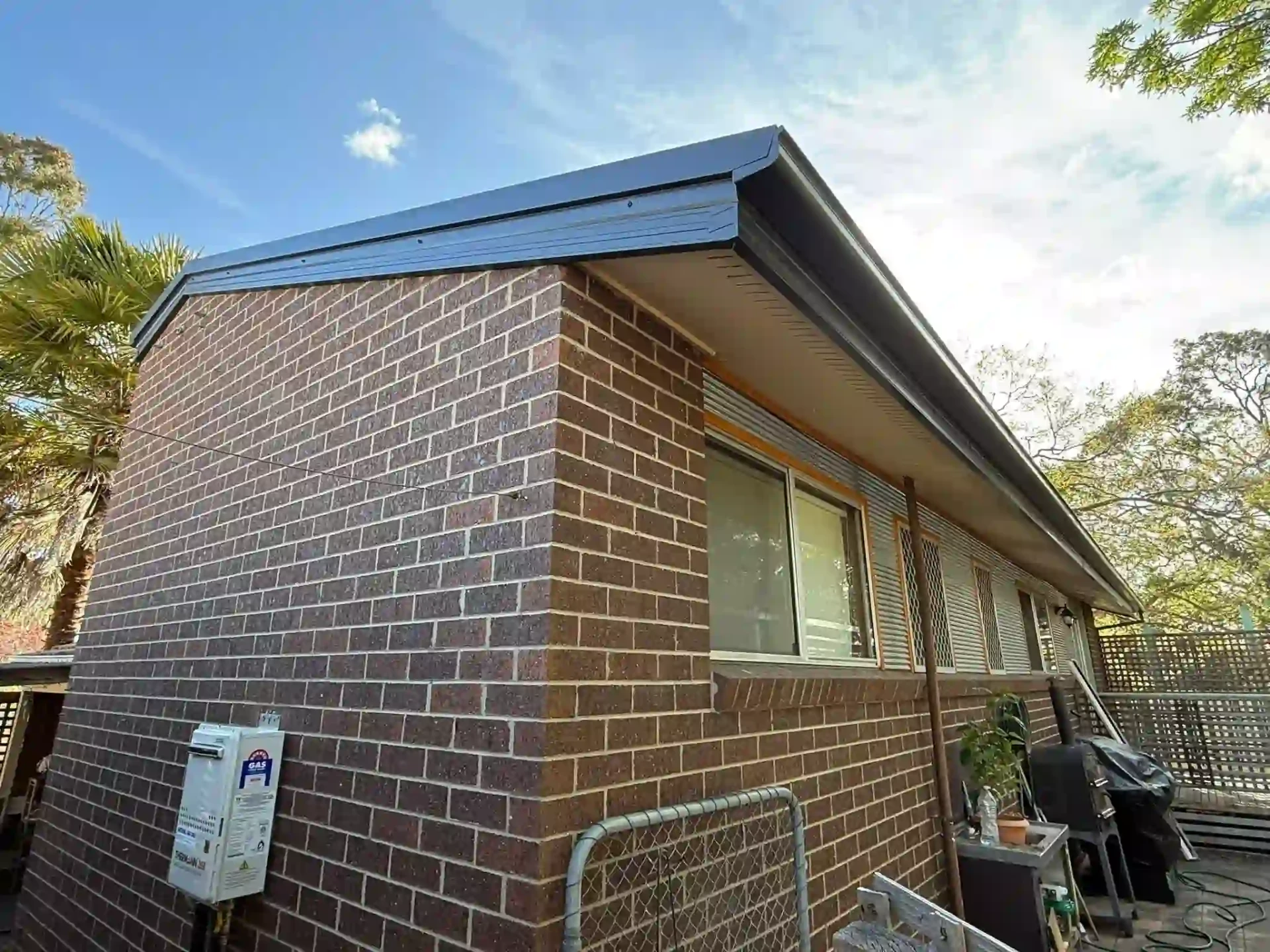 Corner view of the Queanbeyan home with new dark fascia, guttering and roof trim
