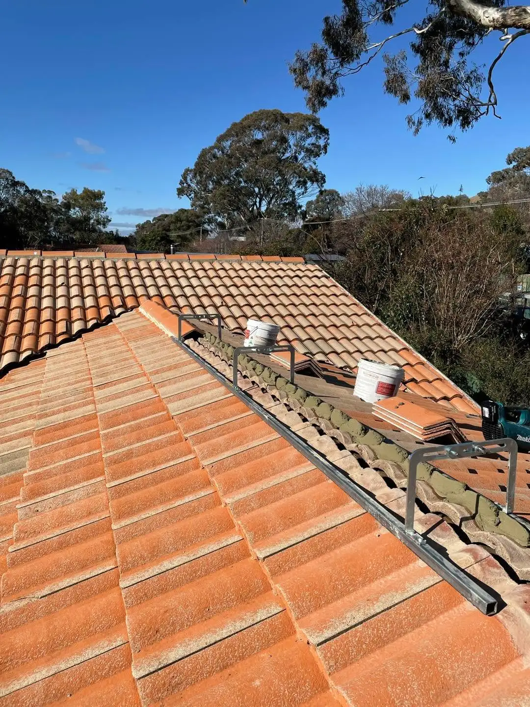 Roofing work in progress on a Canberra tile re-bed and re-point job