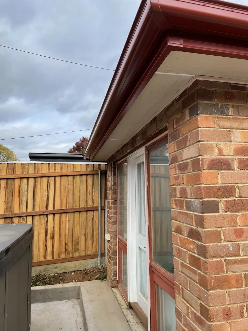 New red guttering, fascia cover and eave sheeting along the cottage roofline